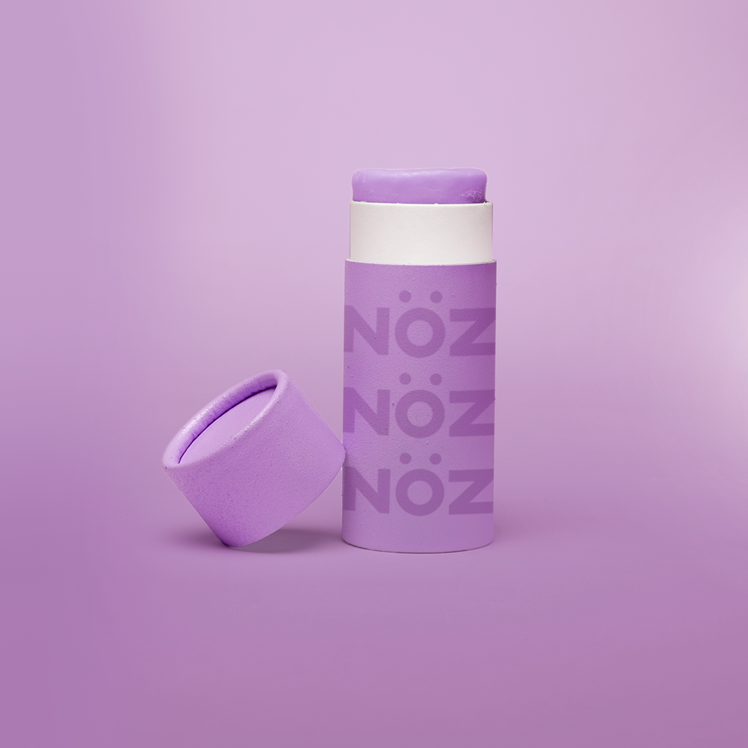 Front view of Neon purple NOZ sunscreen stick with lid off 