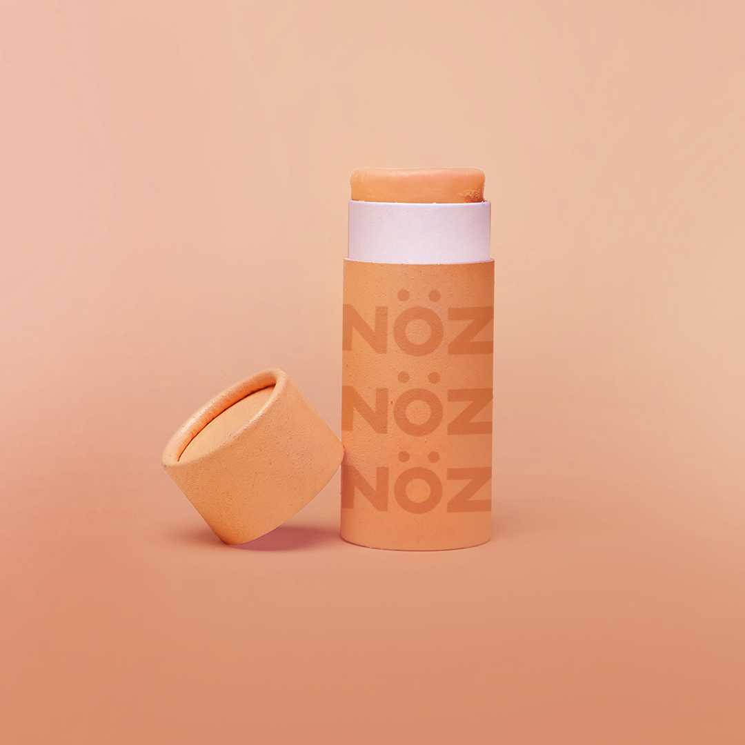 Front view of Neon orange NOZ sunscreen stick with lid off 