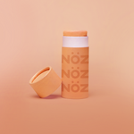 Load image into Gallery viewer, Front view of Neon orange NOZ sunscreen stick with lid off 
